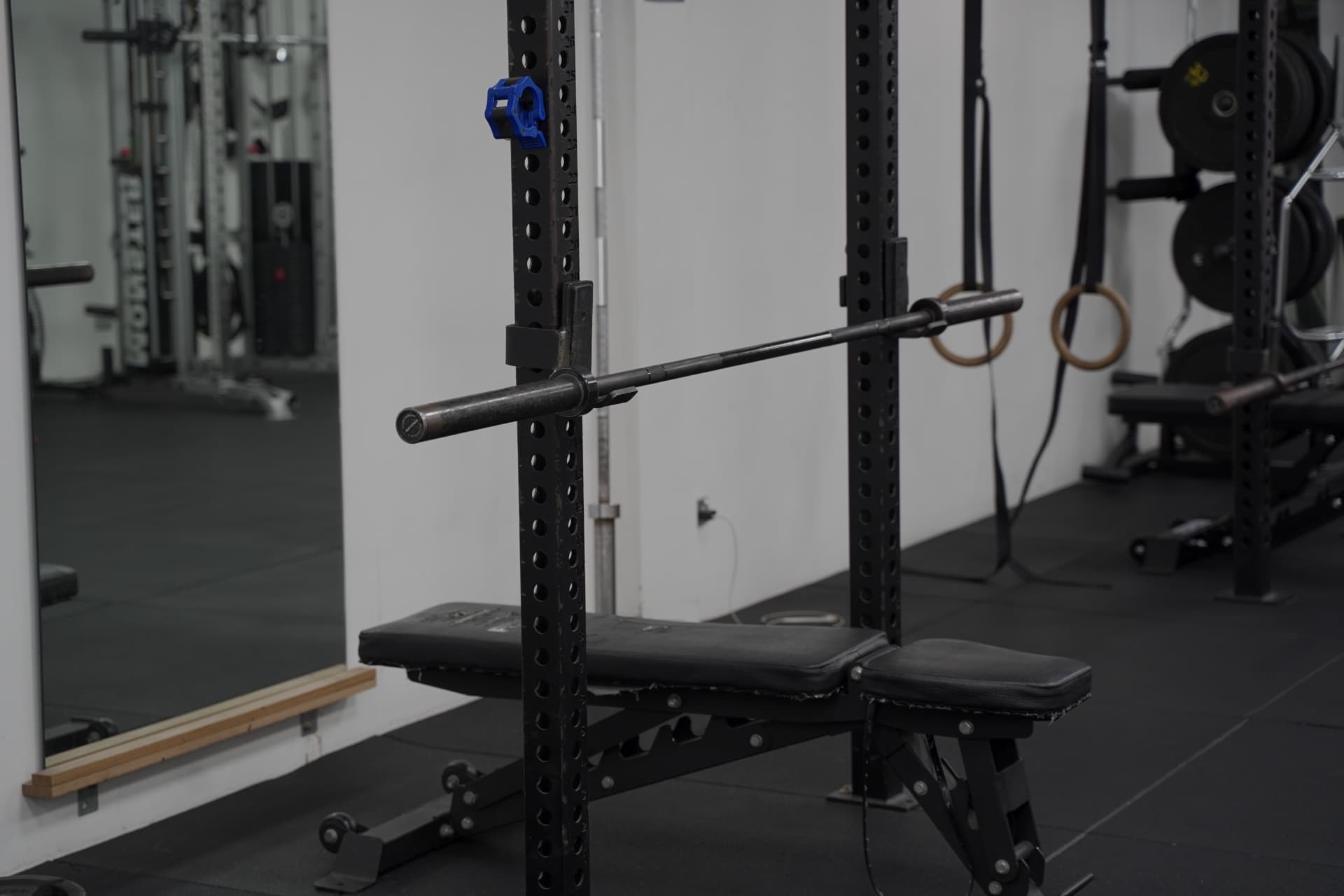 Barbell and bench set up in a squat rack used for rehab loading